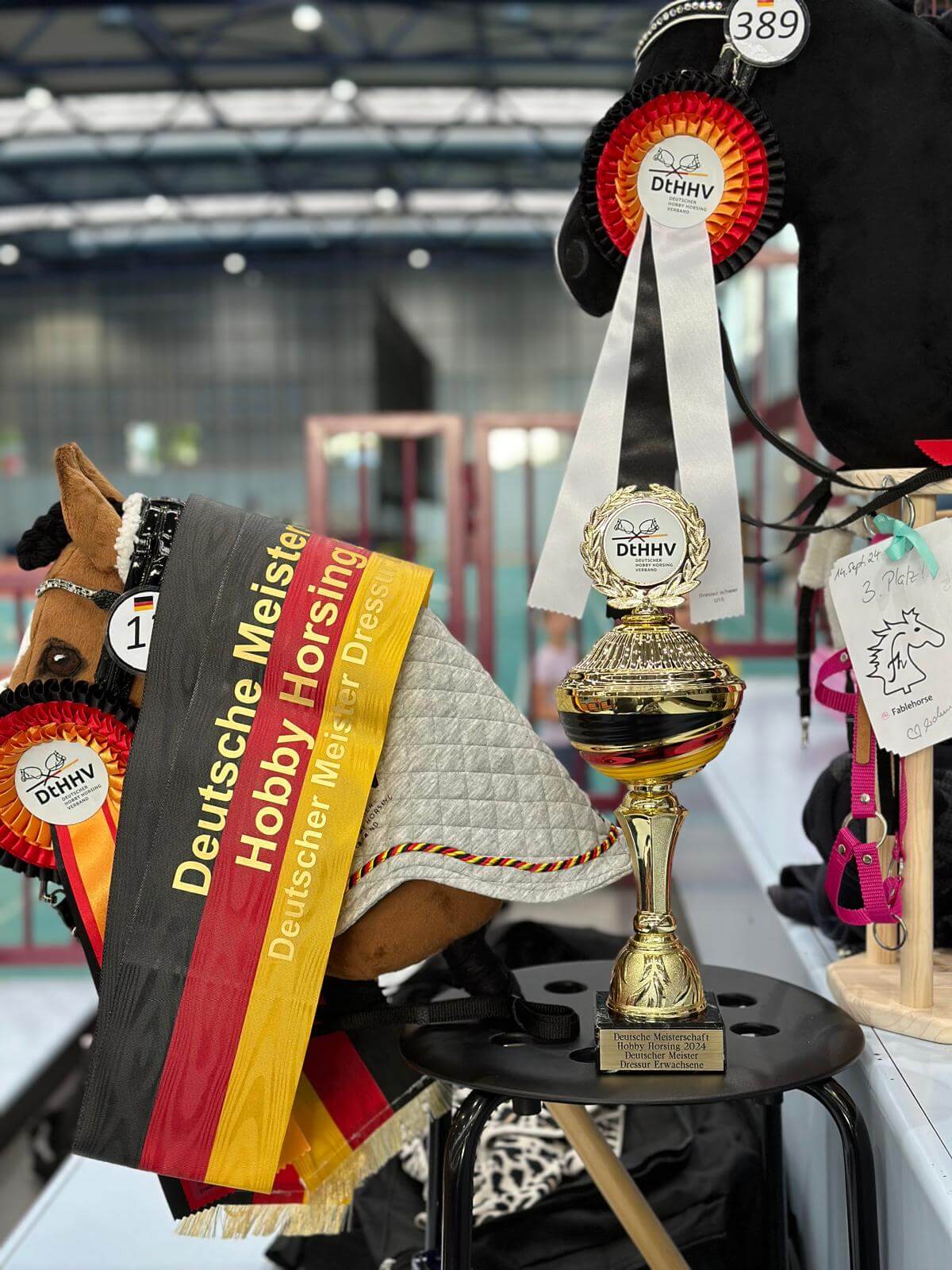 Hobby Horses displayed with German championship ribbons, rosettes and a gold trophy