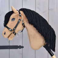The Hobby Horse Samantha with Black Halter by Hobby Horse LarDen features a tan face, black yarn mane, stitched details, and a black halter, presented on a light wooden background.