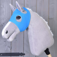 A gray plush hobby horse by Hobby Horse LarDen wears the Horse Mask without ears Sky in blue, covering its eyes, mounted on a wooden stick and set against a wooden plank background.
