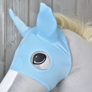 A close-up of a plush toy horse wearing the Horse Mask Sky by Hobby Horse LarDen, featuring pointed ears and an illustrated eye, set against a wooden background.