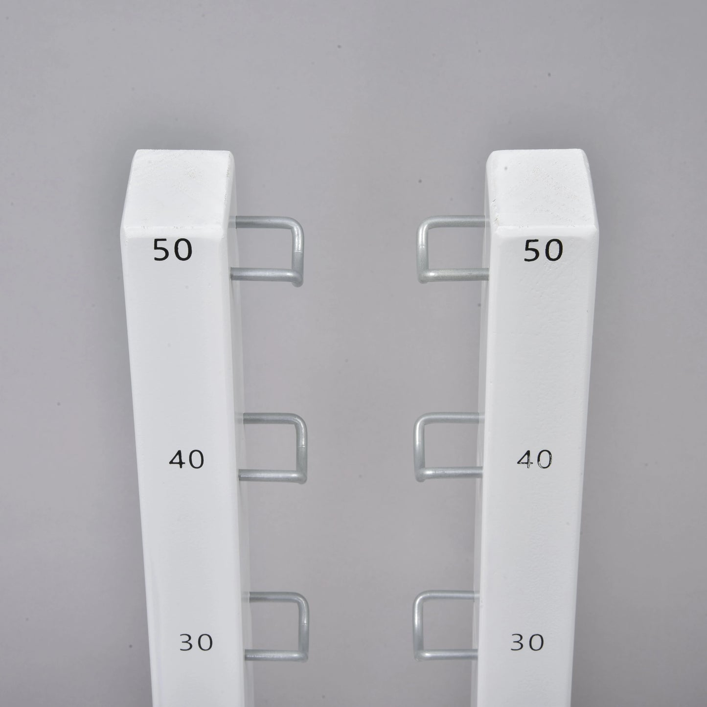 The Hobby Horse LarDen Jump 50 cm / 20 inch features two white vertical metal bars with hooks labeled 30, 40, and 50 in black. Perfect adjustable obstacle for hobby horsing jumps—great for both indoor and outdoor use.