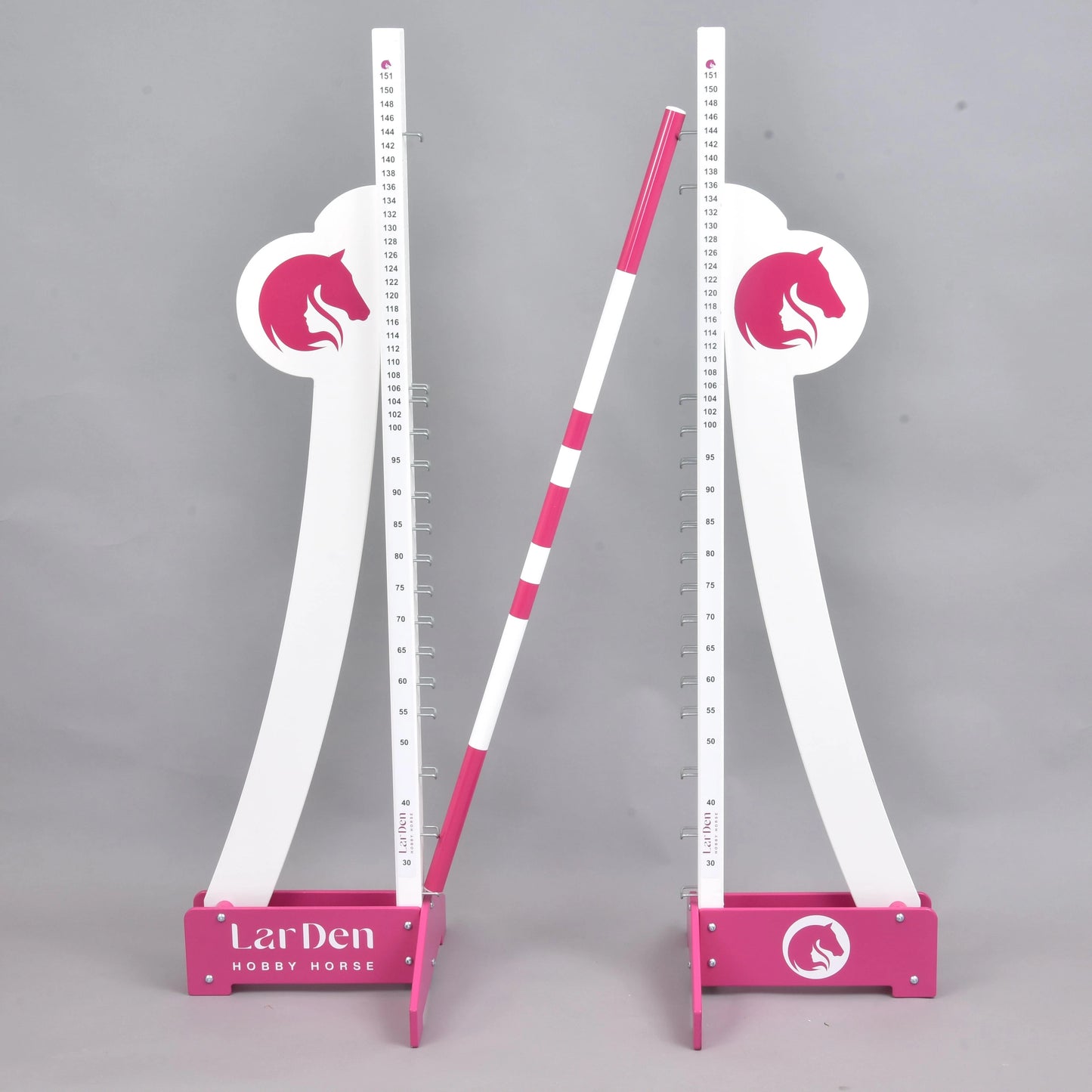 Skok puissance LarDen do Hobby Horse od Hobby Horse LarDen, dwa białe i różowe regulowane stojaki z logo głowy konia podtrzymują poziomo pasiasty drąg, na jednolitym szarym tle.