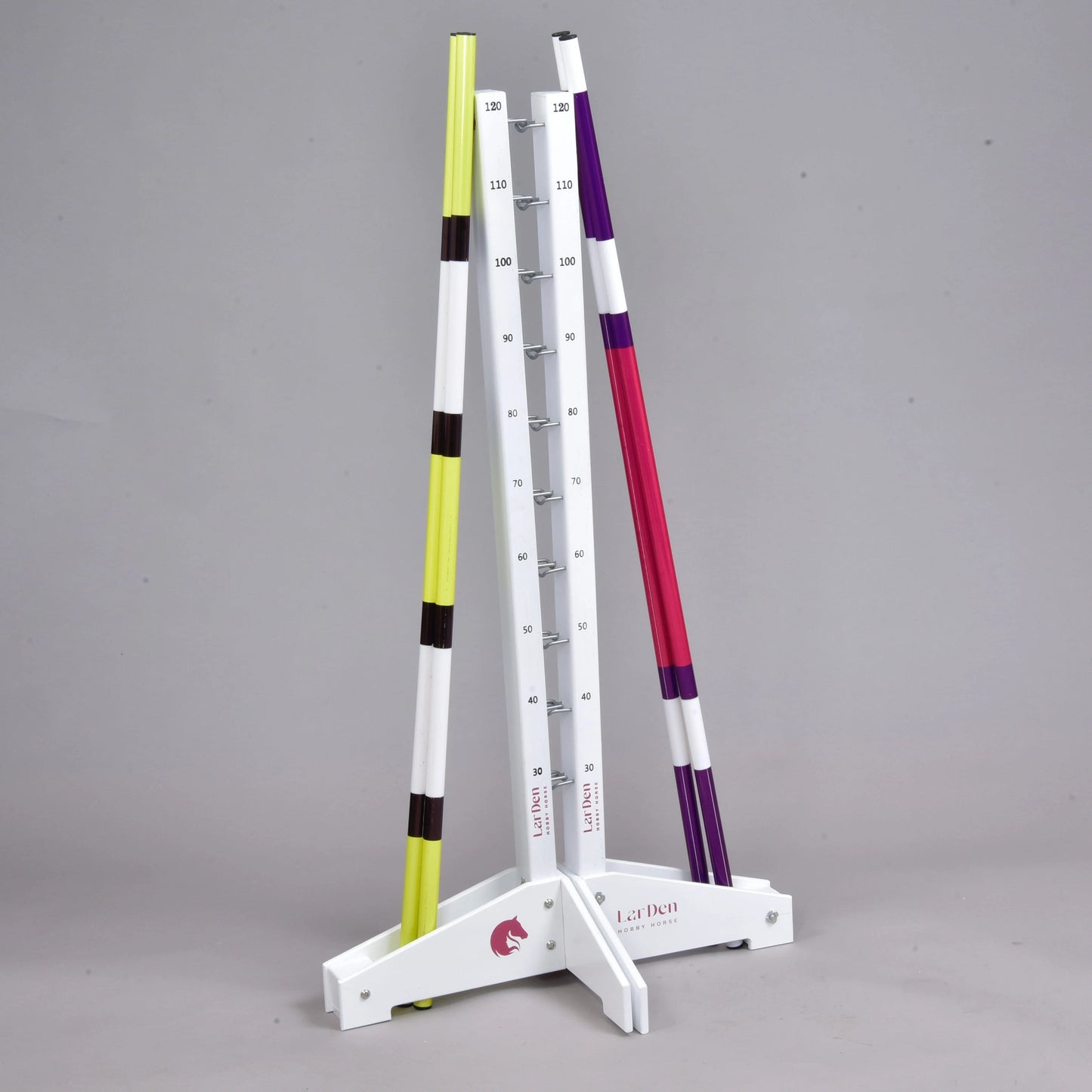 The Hobby Horse LarDen Jump set for Hobby Horsing includes white measuring stands with marked height increments and two striped poles—perfect for adjustable agility or jumping exercises.