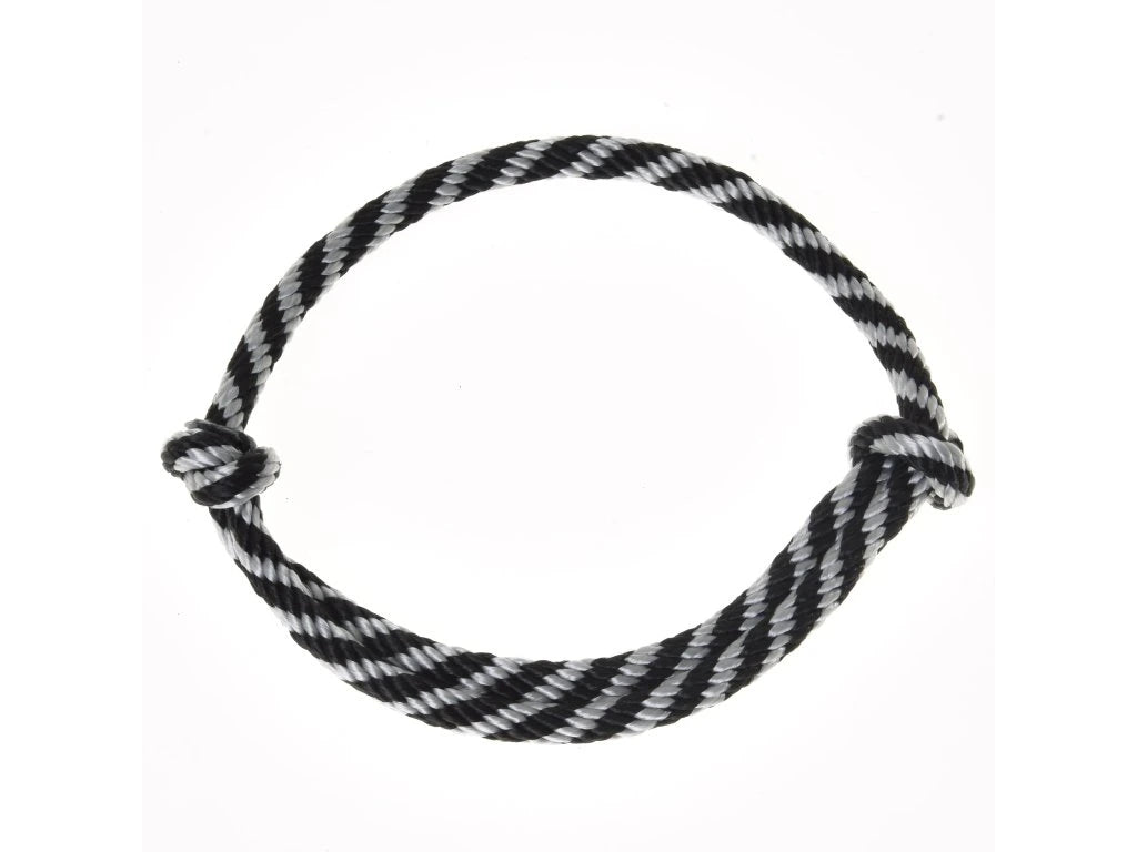 The “Cordeo black stripe” by Hobby Horse LarDen—a black and white striped cordeo, commonly used for bridleless riding or with a hobby horse—is coiled in a circle with knots at both ends and displayed against a white background.