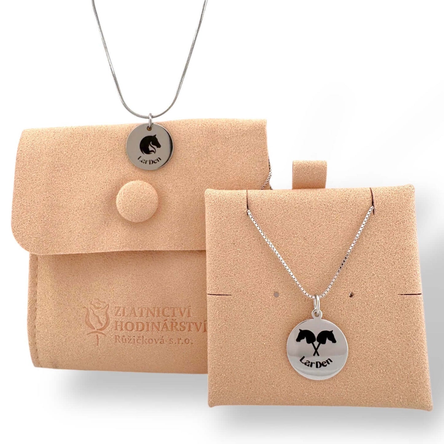 The Silver necklace with Hobby Horse pendant by Hobby Horse LarDen features a 925 sterling silver round pendant with a black horse silhouette and "Larden". Comes with a tan suede jewelry pouch and holder. Perfect for Hobby Horsing fans.