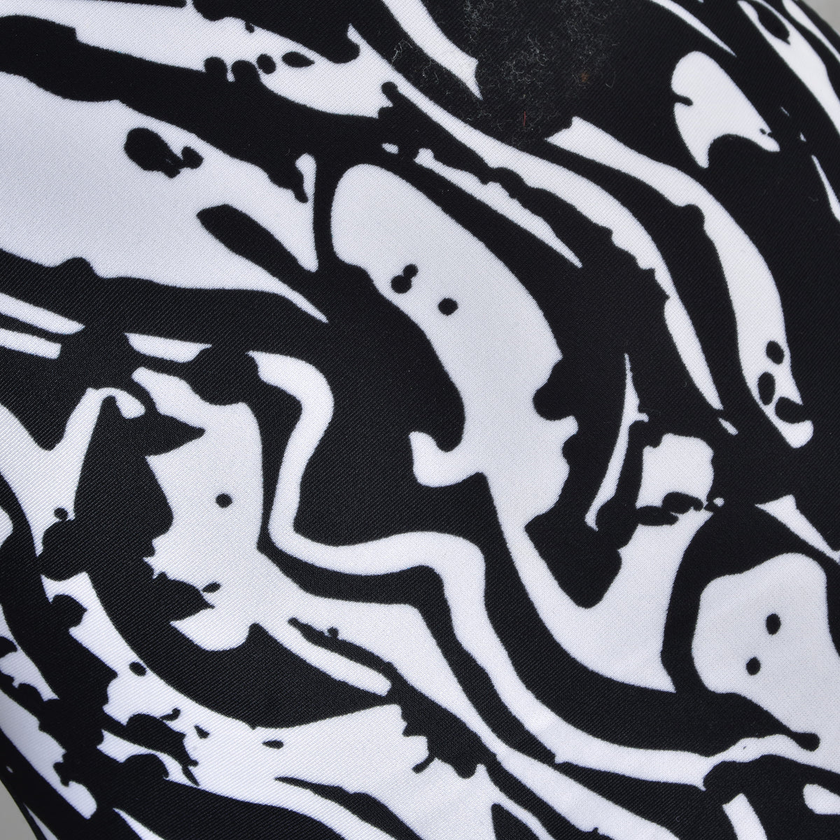 Featuring a striking black and white abstract pattern with swirling, organic shapes and fluid lines that evoke splattered ink or paint on fabric, the Hobby Horse LarDen “Hobby Horse protective suit Black & White” is perfect for adding a dramatic touch to your hobby horse gear.