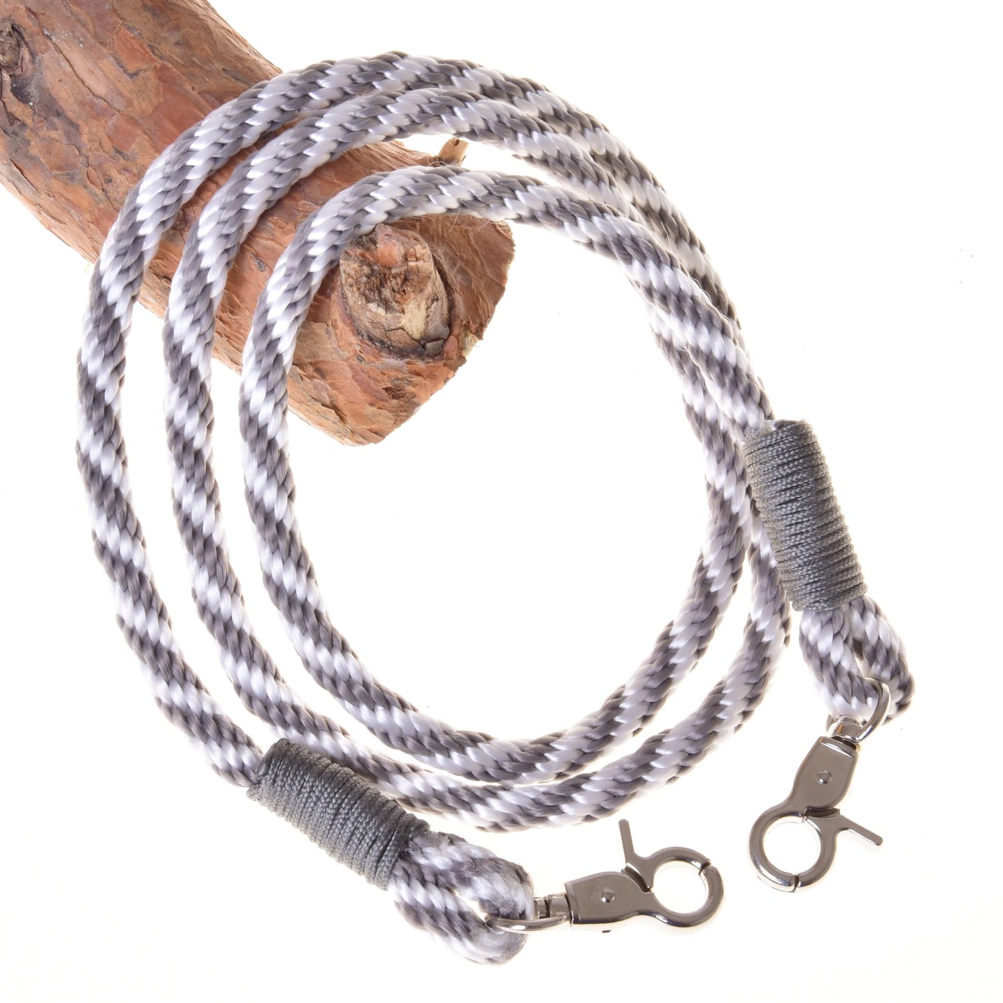 The Set Start Silver by Hobby Horse LarDen includes a halter, cordeo, lead rope, and reins—gray and white twisted rope with metal clasps—perfect for your Hobby Horse collection. Shown looped on wood against a white background.