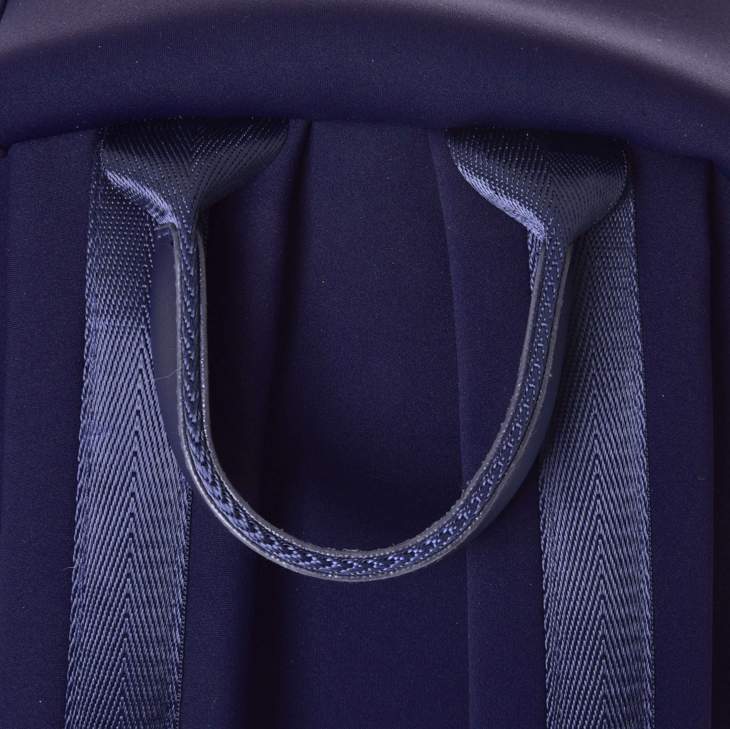 Close-up of the Hobby Horse Backpack LarDen by Hobby Horse LarDen, featuring dark blue neoprene, two padded shoulder straps, and a sturdy top carrying handle.
