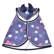 The Raincoat Rainy by Hobby Horse LarDen is a dark blue all-weather pet raincoat with colorful umbrella and raindrop patterns, front zipper, and folded collar—ideal for rainy day walks or Hobby Horse adventures.