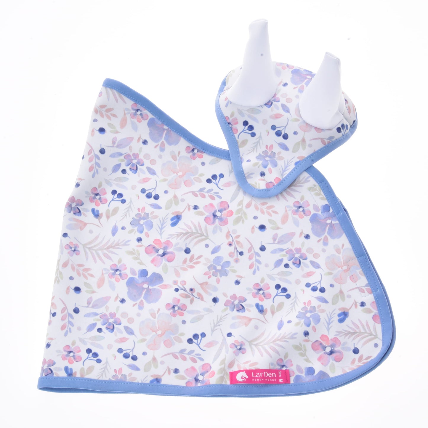 The Set Vanessa NEW by Hobby Horse LarDen includes a baby bib and matching teether with blue trim, both featuring a pink, purple, and blue floral pattern on white. The teether has two white silicone ear-shaped tips, making it a charming nursery set.