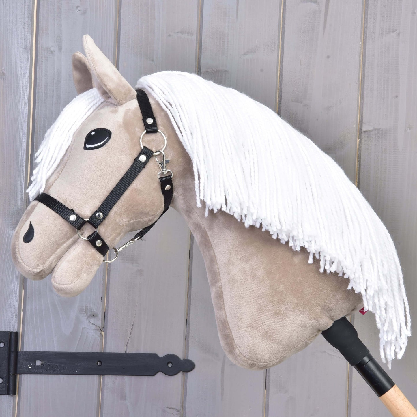 The Hobby Horse LarDen Hobby Horse Blondie with Black Halter features a beige face, white mane, and wooden stick—perfect for any family horse enthusiast.
