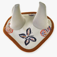 The Ear Bonnet Butterfly (softshell) by Hobby Horse LarDen is a fabric baby bib featuring soft white horns and a colorful butterfly pattern, inspired by insect-protection ear bonnets and finished with a brown border.