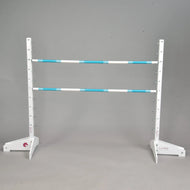 The Hobby Horse LarDen Jump 120 cm / 47 inch set includes two white and blue-striped vertical posts with numbered markers and two horizontal poles made of sturdy wood, shown against a plain gray background.
